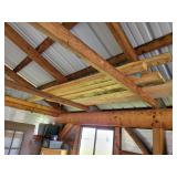 Lumber in garage rafters bring a ladder