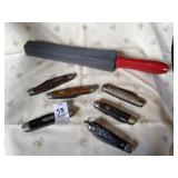 Six pocket knives, sharpening stone with handle