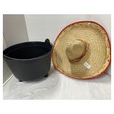Mexican straw hat, plastic kettle
