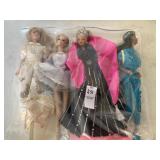 Four Barbie dolls
