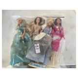 Four Barbie dolls