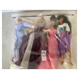 Four Barbie dolls
