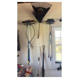 Lot of Brooms and Rakes on Wall