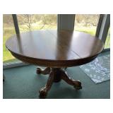 Oak pedestal dining table with carved lion claw