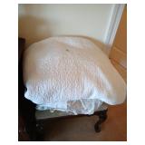 Stack of bedding, quilt, sheets, pillow and