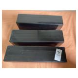 Three black plastic storage boxes designed to