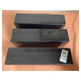 Three black plastic storage boxes designed to