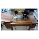 Vintage Singer sewing machine in cabinet