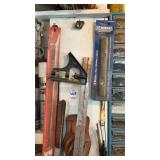 Level square, coping saw blades, etc. hanging on