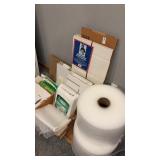 Lot of packing paper, bubble wrap, and cardboard