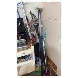 Corner lot of mops, brooms, etc