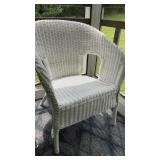 White wicker armchair with arched back
