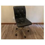 Black adjustable office chair on casters