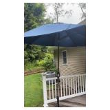 Blue patio umbrella features a crank lift with a