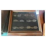 Framed collection of antique spectacles