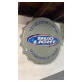 Silver-colored Bud Light bottle cap wall sign