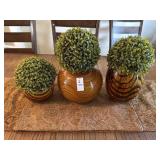 Faux plants in vases and table runner with two