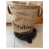 Burlap potato basket on rolling metal trolley