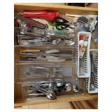 Drawer of assorted flatware and kitchen utensils