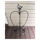 Black metal heart shaped plant stand with