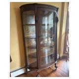 Rounded glass China cabinet with Paw feet..