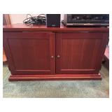 Cherry colored 2-door tv stand 44 X 22 X 24 in