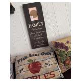 Lot of decorative pillows and family sign