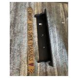 Wooden shelf with hooks and sign