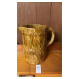 Antique yellowware pitcher with a molded relief