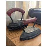 Antique cast iron sad irons one with stand