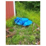Big blue tarp outside garage across road
