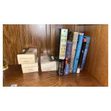 Shelf of Books and Scented Votives
