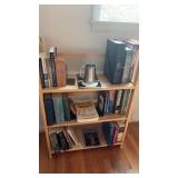 Contents of book shelf - books and a mug