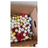 Big box of various branded golf balls