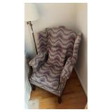 Traditional wingback armchair featuring a zigzag
