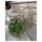 Glass lidded storage containers with loose green