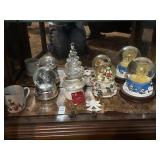 Shelf lot of Christmas snow globes, snow white