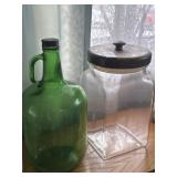 Green gallon jug and glass storage canister