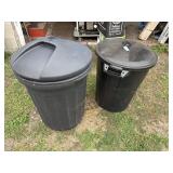 Two plastic black trash cans