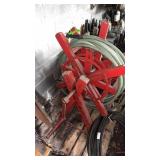 Vintage wooden garden hose reel with manual hand