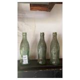 Vintage green glass Coca-Cola hobbleskirt bottles
