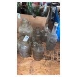 Lot of vintage clear glass jugs and bottles -