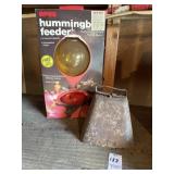 Vintage cowbell and hummingbird feeder