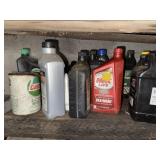 Shelf lot of assorted motor oil and pump oil can
