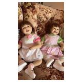 Two lifelike collectible vinyl toddler dolls