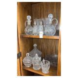 Two Shelves of Glass Jars and Decanters