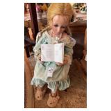 Vintage Collectible porcelain doll seated in a