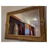 Mirror with ornate gold plastic frame