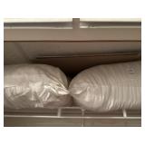 Lot of pillows and plastic zip containers