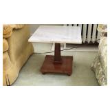 Vintage wooden pedestal side table topped with a